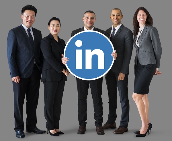 Business people standing and holding globe icon