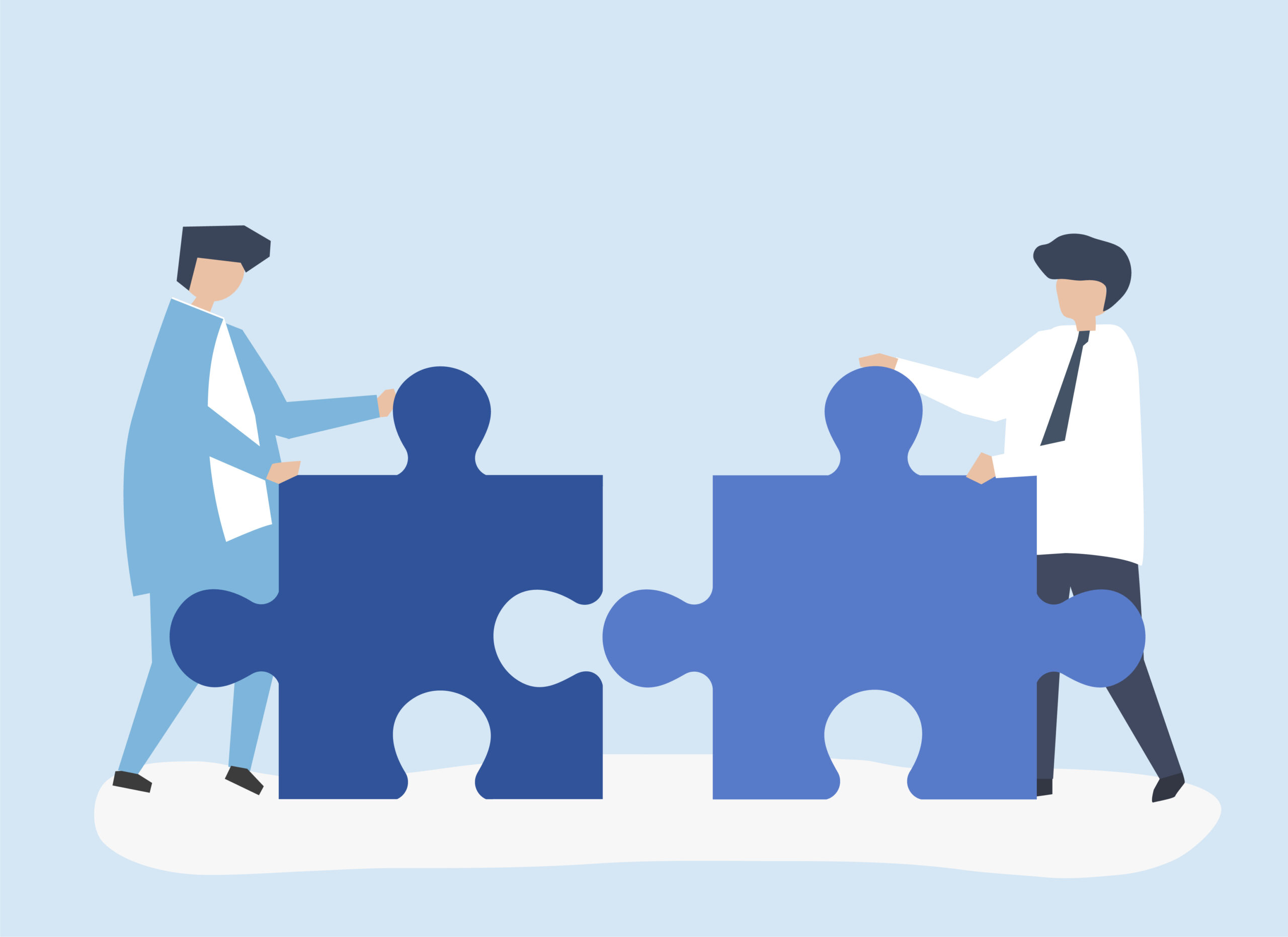 Colleagues connecting jigsaw pieces together