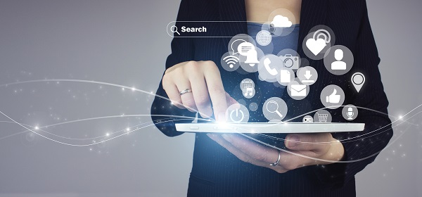 Social media concept. Communication network. White tablet in businesswoman hand with digital hologram social media icons sign on grey background. Social media and digital online concept.
