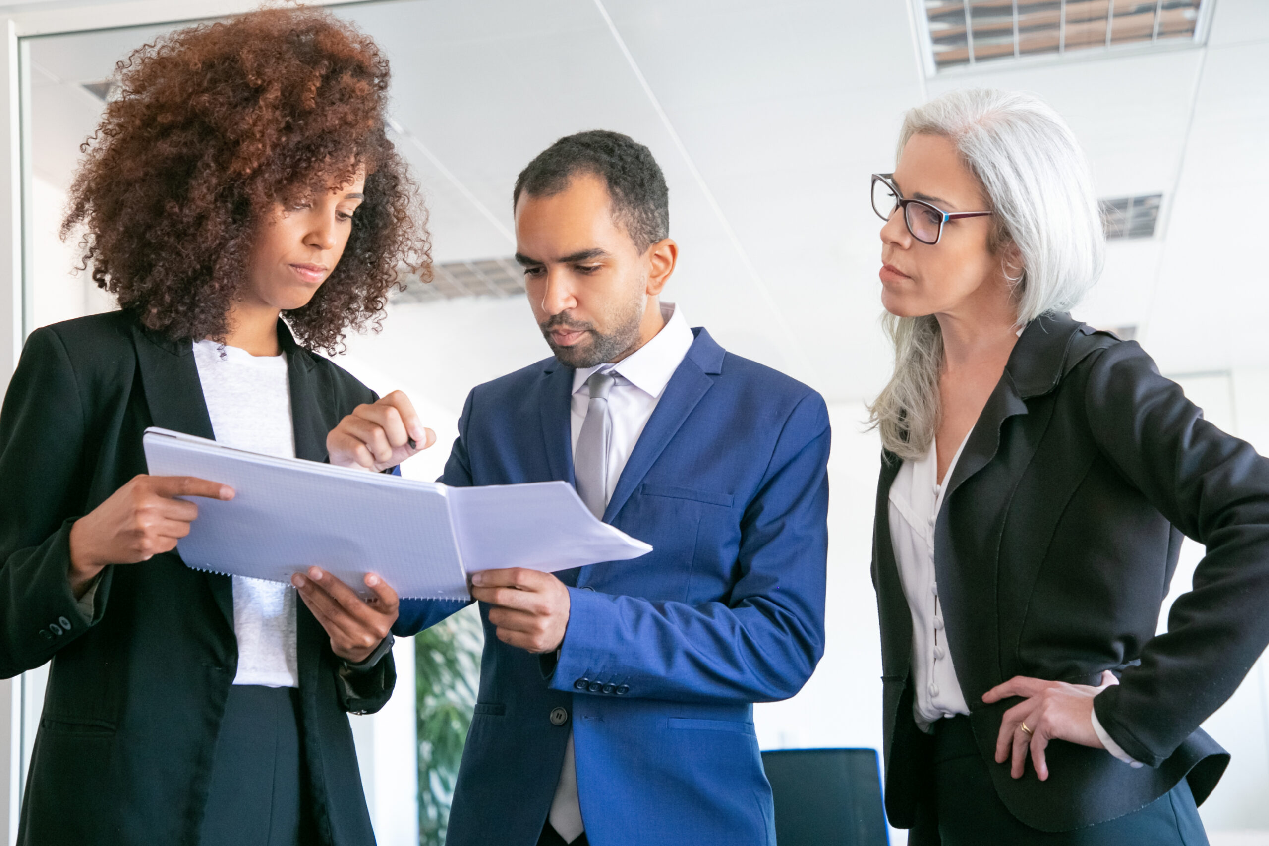 Confident office employers checking documents together